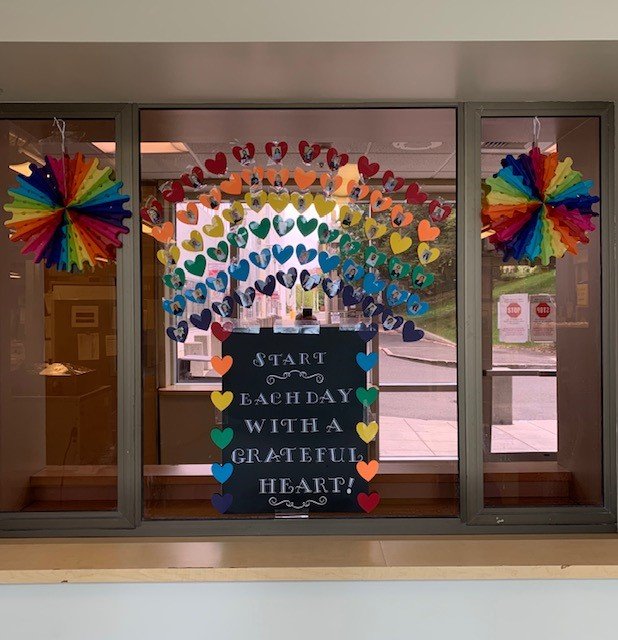 hospital window with decorations of hearts and a quote