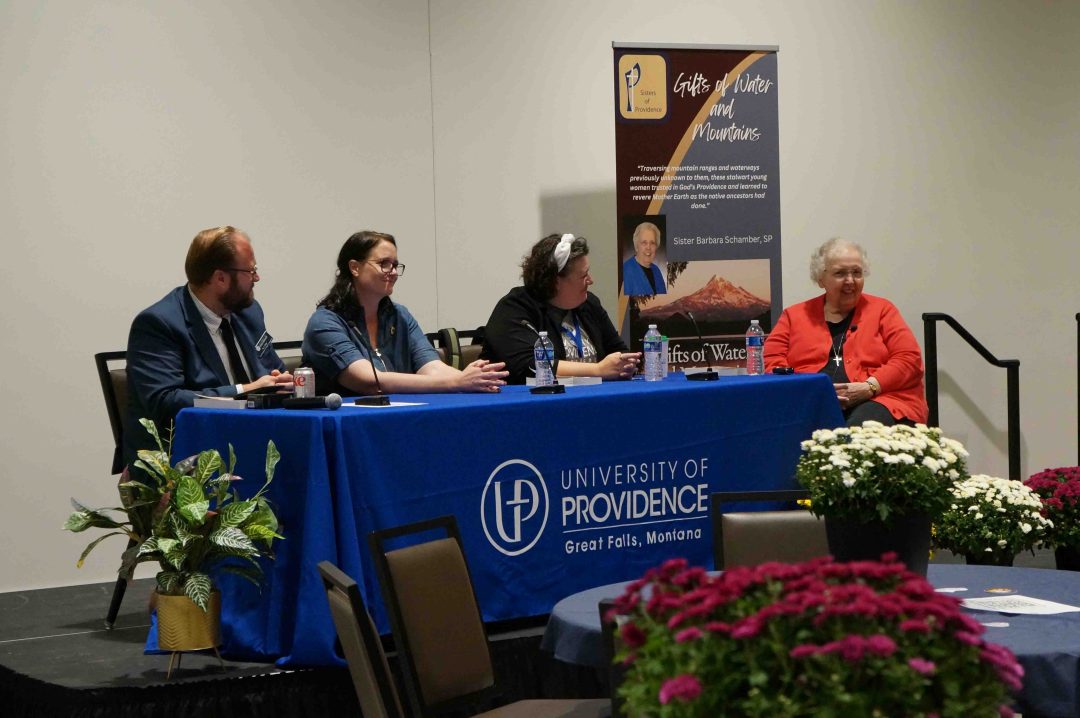 Four people on a dais