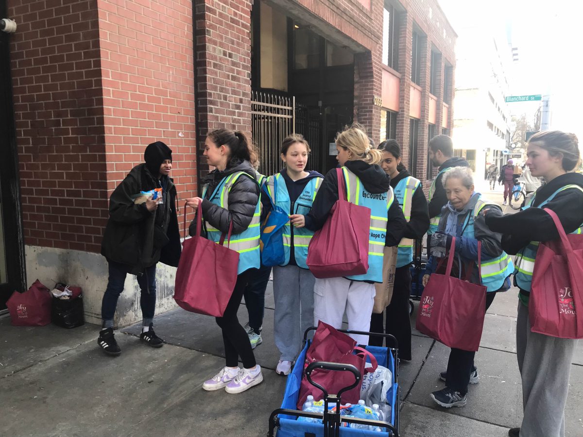 a group of high school students with bags of food