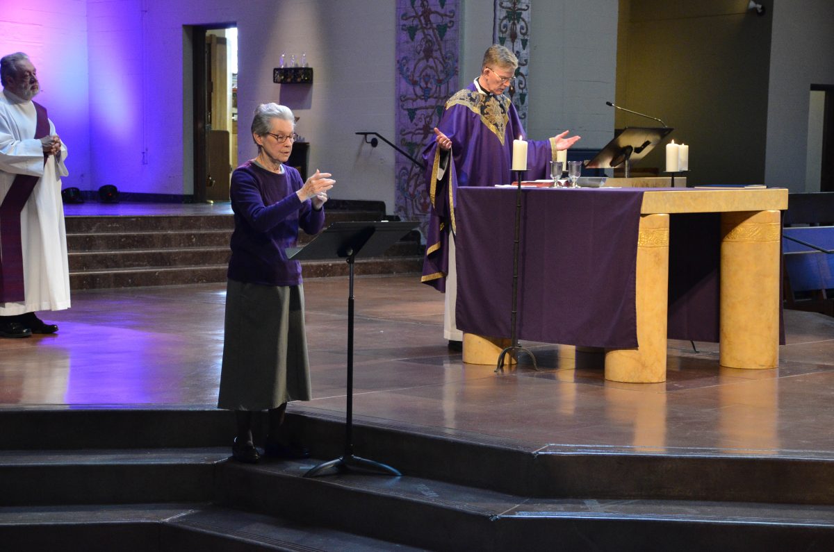 woman interprets for deaf congregants at a catholic mass