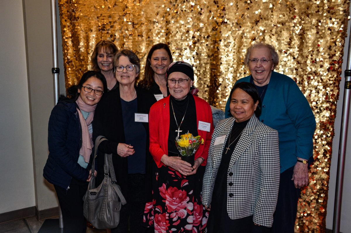 a group of women pose for a photo