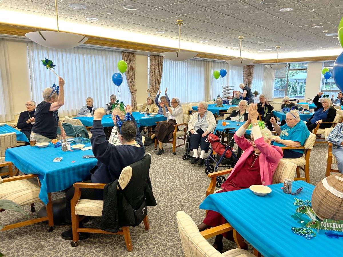 Several Sisters of Providence celebrate a Seahawks field goal during a Super Bowl watch party.