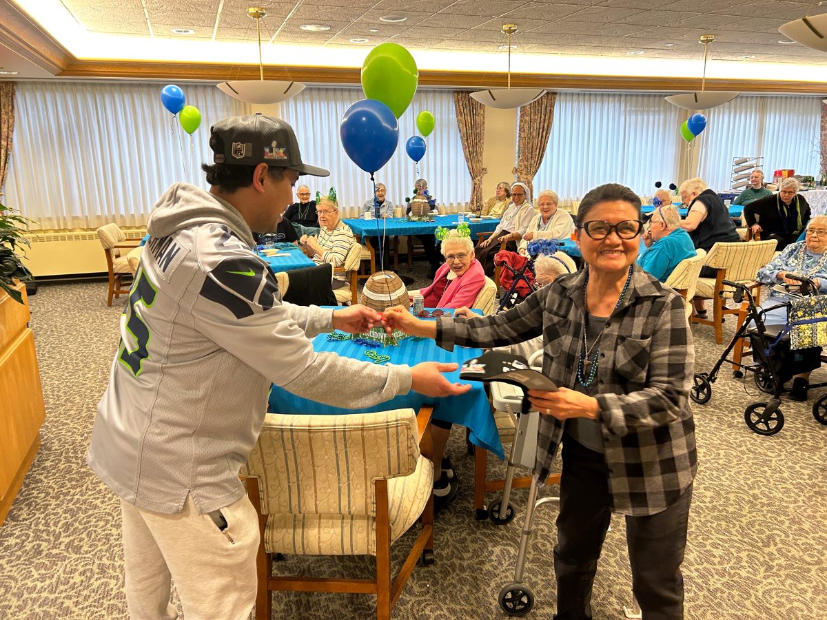 A religious sister receives a raffle winning.