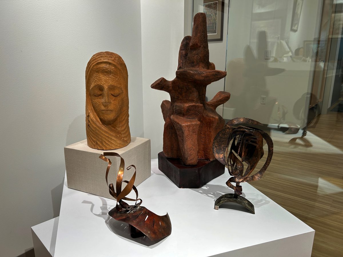 A mix of ceramic and metal sculptures on display.