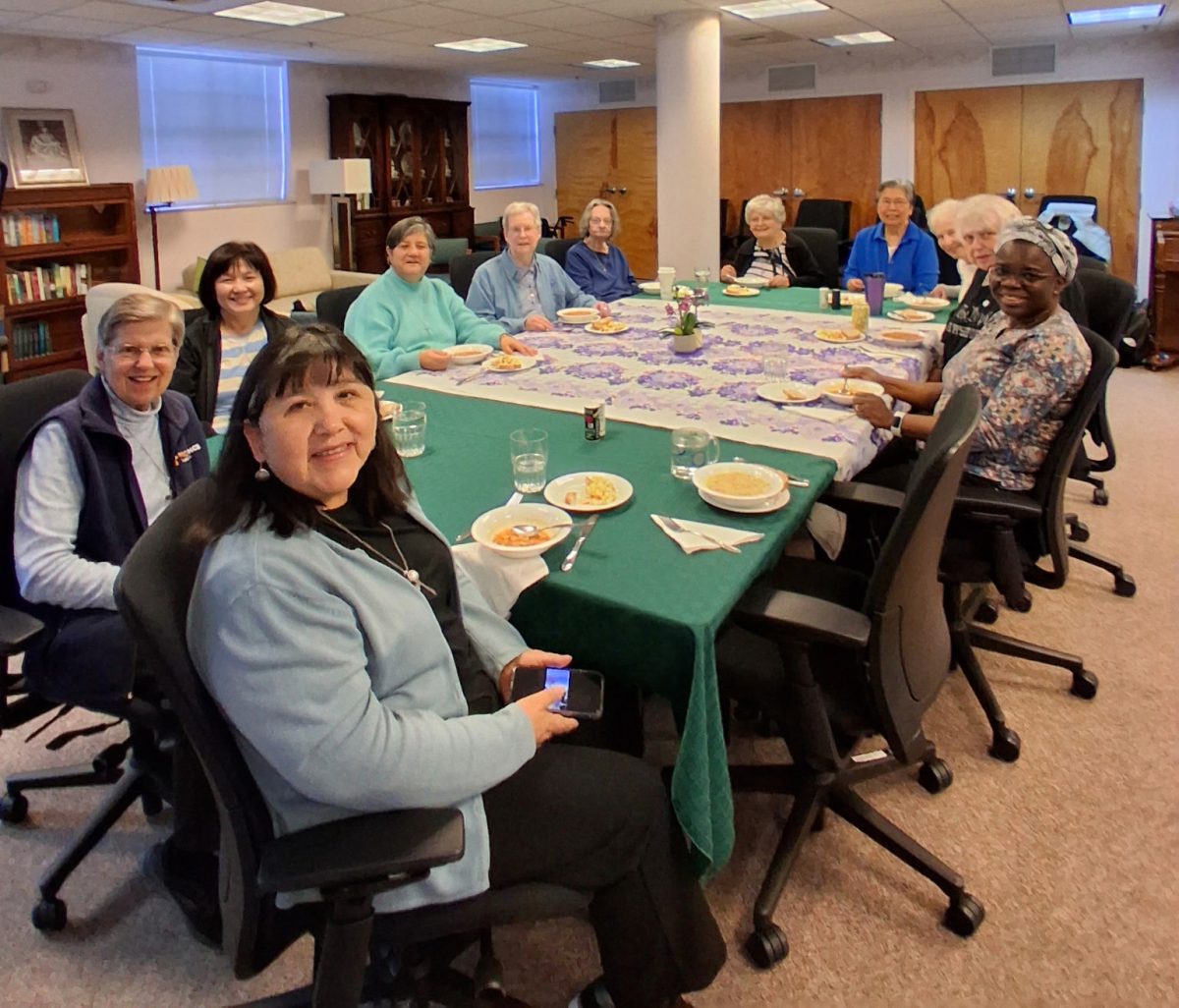 Sisters of Providence pose while convening for a meal.