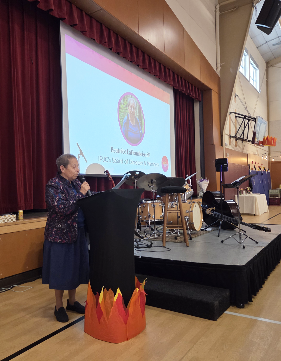 A religious Sister addresses a social justice summit.