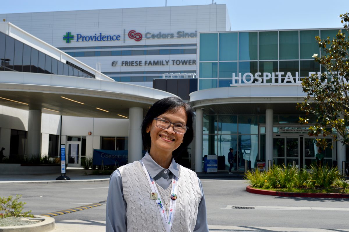 Sr. Phoung Ha Nguyen poses in front of a hospital.