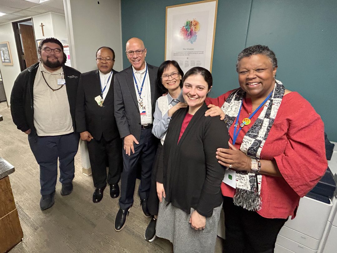 Sr. Phuong Ha Nguyen stands for a posed picture alongside her Spiritual Care team.