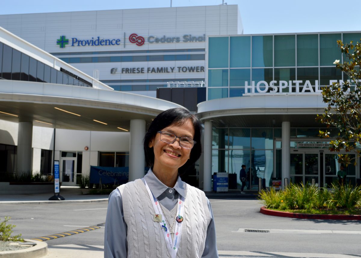 Chaplain Sr. Phuong Ha Nguyen poses for a portrait in front of the hospital she serves.