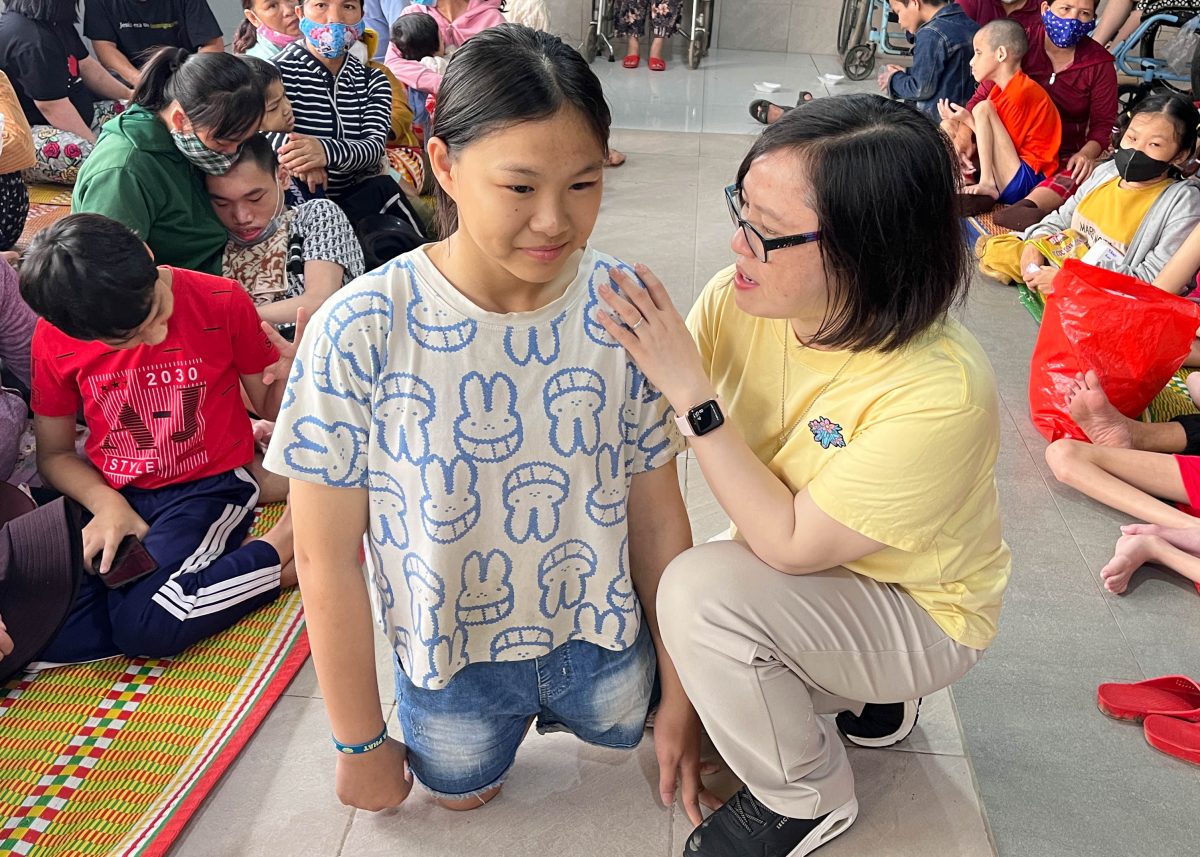 Sr. Rosa Nguyen supports a young girl at a health clinic in Vietnam.